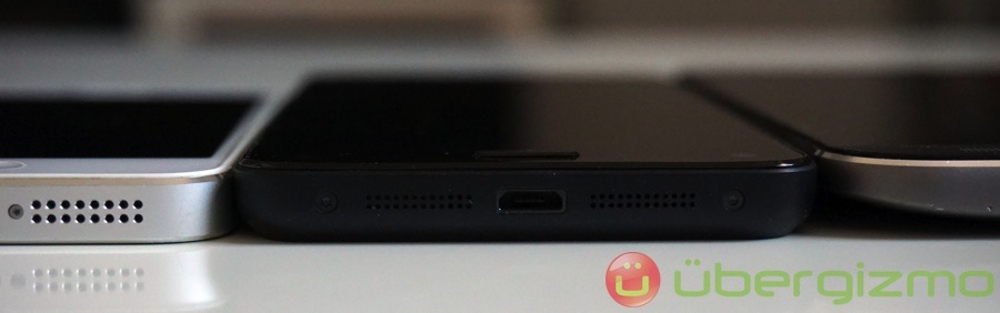 Thickness comparison between iPhone 5, Fire Phone, and HTC One (M8).