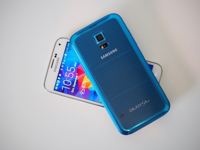 A soft-touch rubberized back on the blue Galaxy S5 Sport makes it easier to grip than the faux leather of the Galaxy S5.